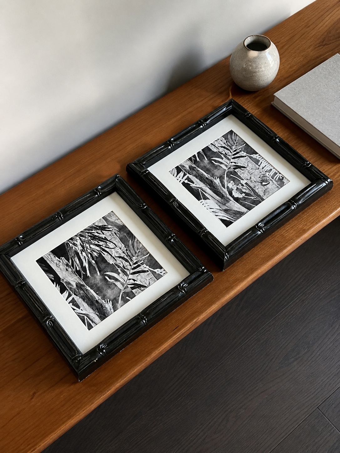 MOOJI ART coordinated botanical pair arranged on a walnut console with black carved frames and cream mats